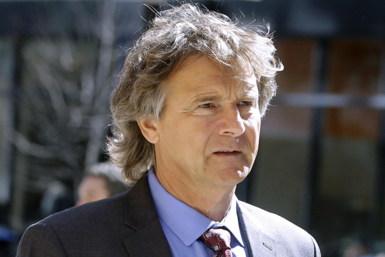 FILE - Jovan Vavic, a former University of Southern California water polo coach, arrives at federal court in Boston, March 25, 2019, to face charges in a nationwide college admissions bribery scandal. Opening arguments began, Thursday, March 10, 2022, in Boston federal court in Vavic's racketeering case, the only coach of the many implicated to take his case to trial.