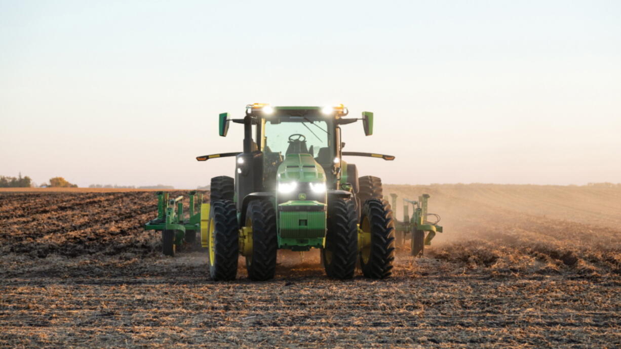 An autonomous tractor plows a field -- without a driver -- on a farm in Blue Earth, Minn., in 2021.