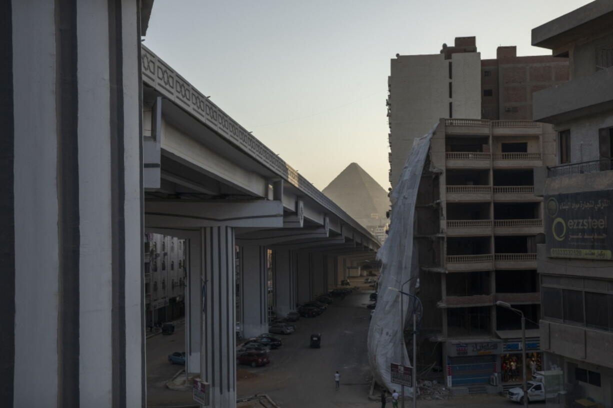 FILE - A bridge under construction is part of mega projects that include building new cities, roads, bridges and tunnels as the government tries to ease traffic on congested roads in one of the world's most crowded cities, in the Giza suburb of Cairo, Egypt, July 19, 2021. The massive road construction projects have erased some of the oldest remaining green spaces in Egypt's capital.