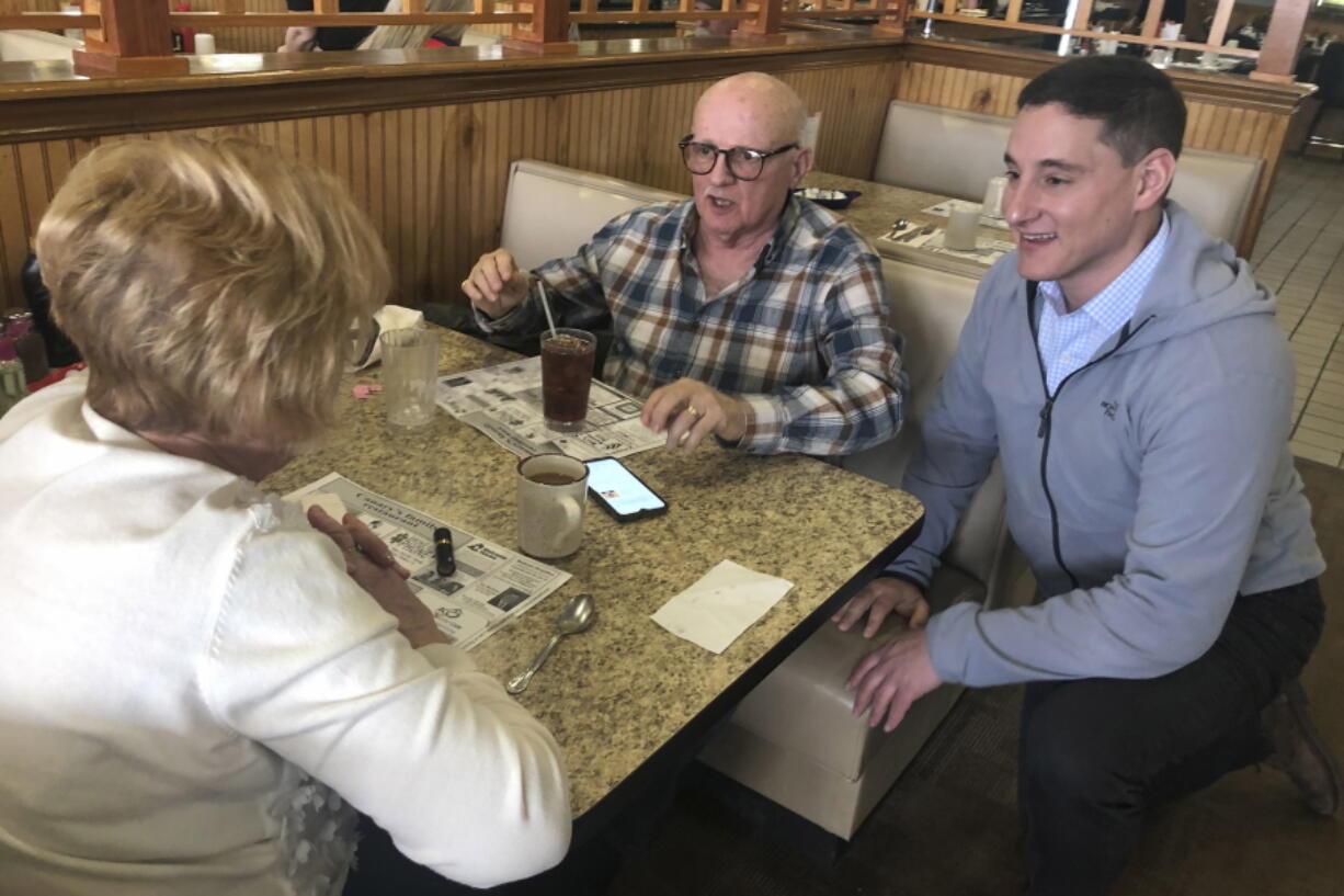 Republican Senate candidate Josh Mandel chats with Star and Bruce Clark at Canary's Family Restaurant in North Olmsted, Ohio, March 9, 2022.  Ohio's crowded Republican Senate race has been all about one man: Donald Trump. But with less than two months until the state's May 3 primary to succeed retiring Sen. Rob Portman, some of the leading candidates have accepted that, despite their best efforts, the former president's coveted endorsement may never come.