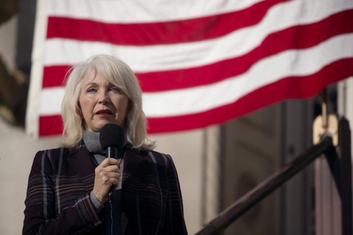 FILE - Mesa County, Colo., clerk Tina Peters speaks during a truth and justice rally on Dec. 1, 2021, outside the old Mesa County Courthouse in Grand Junction, Colo.   A grand jury in Colorado has indicted Peters, a county election clerk who has sowed doubt about the 2020 presidential election, alleging she was part of a "deceptive scheme" to breach voting system technology that is used across the country.