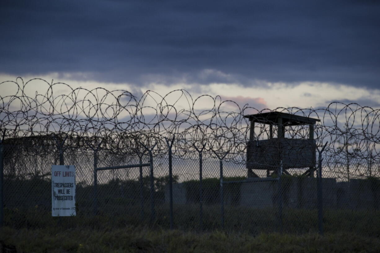 FILE - In this photo reviewed by U.S. military officials, the sun sets behind the closed Camp X-Ray detention facility, on April 17, 2019, in Guantanamo Bay Naval Base, Cuba. The Biden administration has been quietly laying the groundwork to release prisoners from the Guantanamo Bay detention center and at least move closer to being able to shut it down.