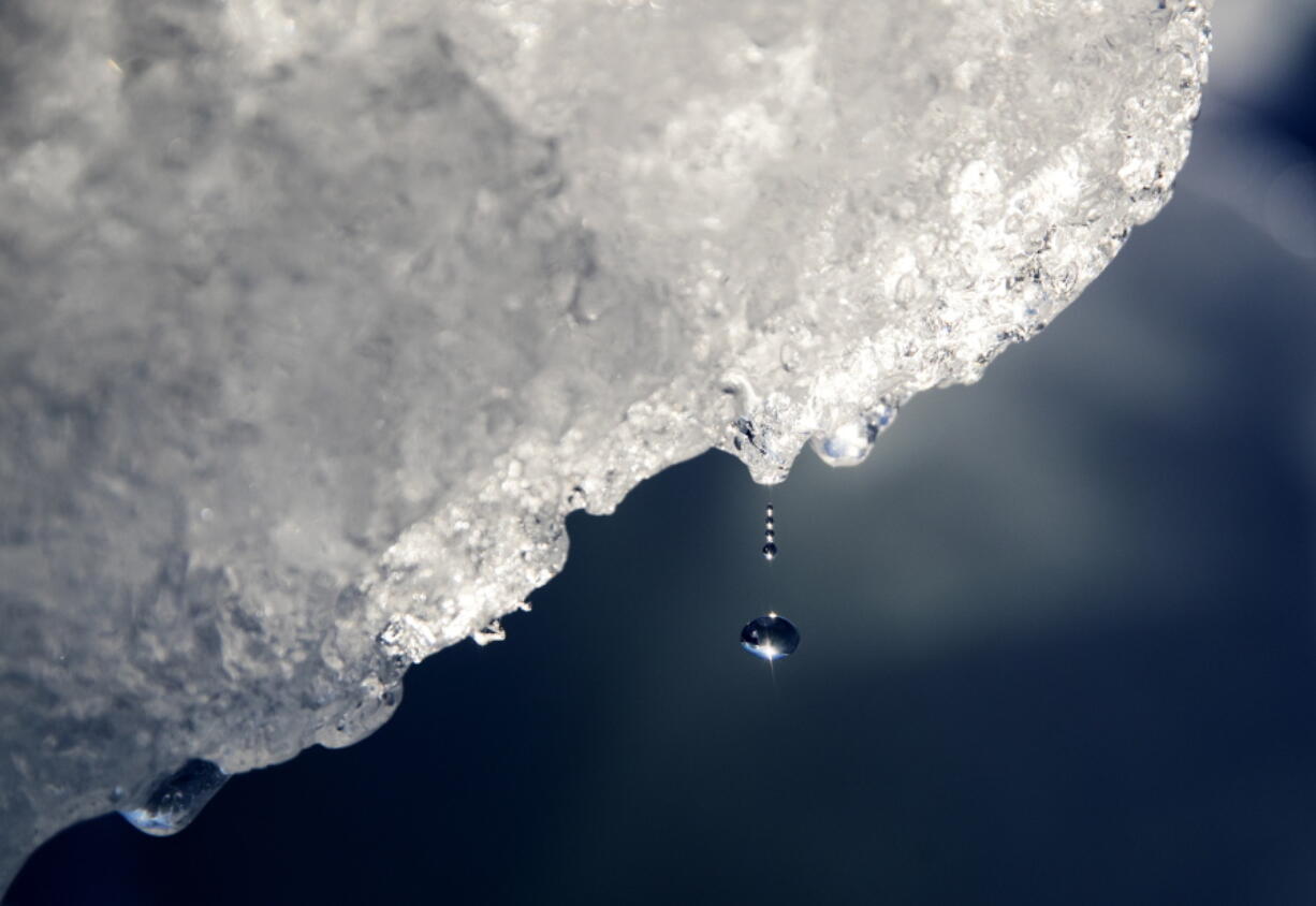 A drop of water falls from a melting iceberg in the Nuup Kangerlua Fjord near Nuuk in southwestern Greenland in 2017.