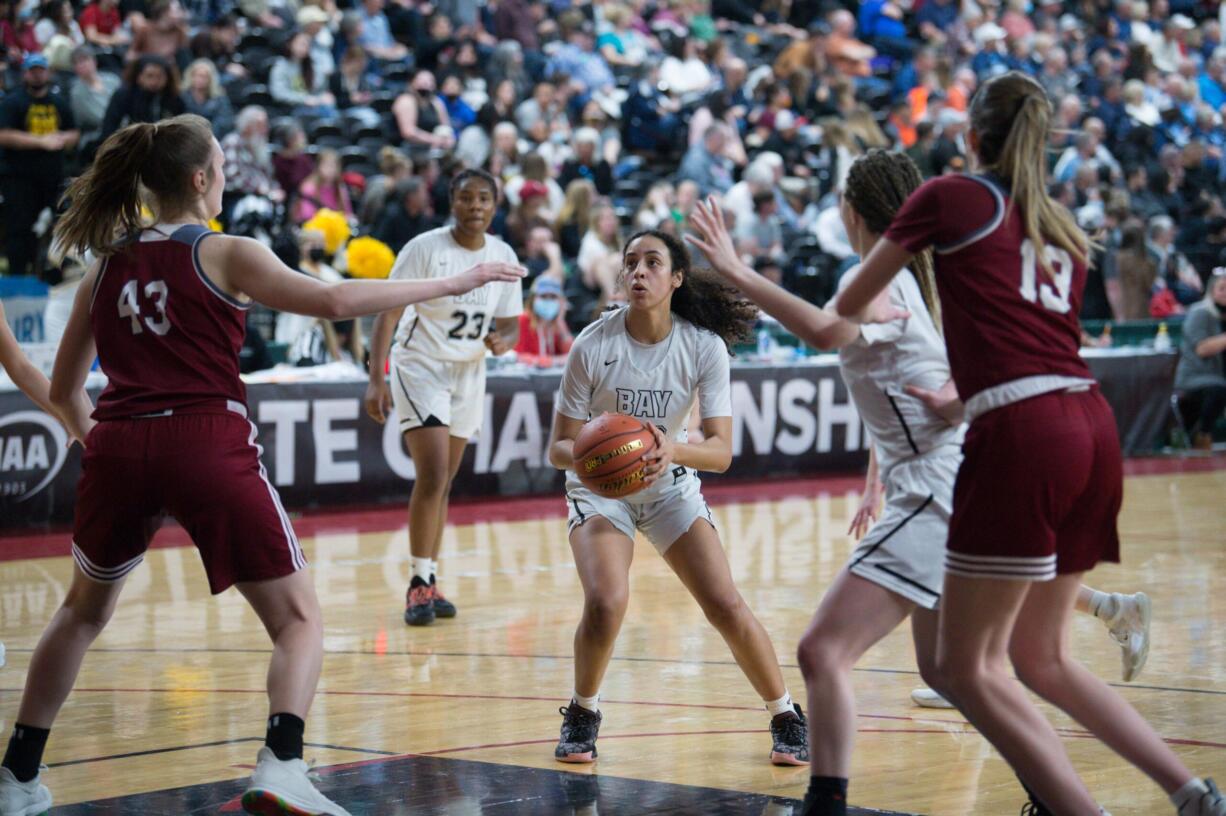 Hudson's Bay junior Mahaila Harrison, center, lines up a jumper near the free-throw line over W.F. West's Julia Dalan, left, in a Class 2A girls state quarterfinal game on Thursday at the Yakima Valley SunDome.