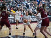 Hudson's Bay junior Mahaila Harrison, center, lines up a jumper near the free-throw line over W.F. West's Julia Dalan, left, in a Class 2A girls state quarterfinal game on Thursday at the Yakima Valley SunDome.