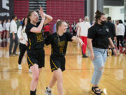 Hudson's Bay players Paytin Ballard, left, and Promise Bond celebrate after a 54-53 win over West Valley of Spokane at the Class 2A girls basketball state tournament on Friday, March 4, 2022 in Yakima (Micah Rice/The Columbian)