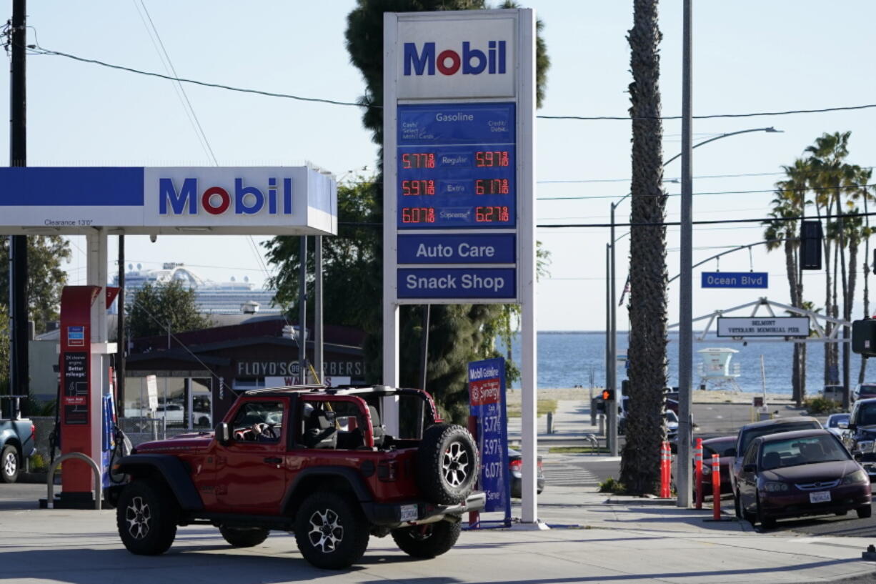 FILE - Gas prices are displayed at a gas station Friday, March 11, 2022, in Long Beach, Calif.  Rebates or cash payments are being proposed in California, New Mexico, Pennsylvania and elsewhere as states are flush with cash and Americans are facing the highest inflation in four decades.