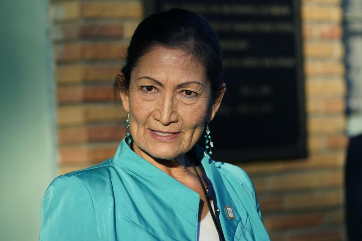 FILE - Secretary of the Interior Deb Haaland speaks with reporters while standing outside the Medgar and Myrlie Evers Home National Monument in Jackson, Miss., on Feb. 15, 2022. The Interior Department is on the verge of releasing a report on its investigation into the federal government's past oversight of Native American boarding schools. Interior Secretary Deb Haaland said Wednesday, March 16, 2022, the report will come out next month. (AP Photo/Rogelio V.