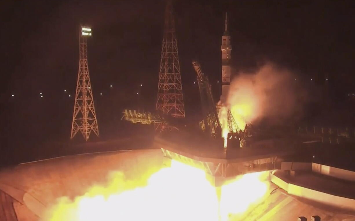 In this photo taken from video footage released by the Roscosmos Space Agency, the Soyuz-2.1a rocket booster with Soyuz MS-21 space ship carrying Russian cosmonauts Oleg Artemiev, Denis Matveev and Sergei Korsakov to the International Space Station, ISS, blasts off at the Russian leased Baikonur cosmodrome, Kazakhstan, Friday, March 18, 2022.