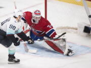 Seattle Kraken's Marcus Johansson (90) scores against Montreal Canadiens goaltender Sam Montembeault, right, during shootout NHL hockey action in Montreal, Saturday, March 12, 2022.