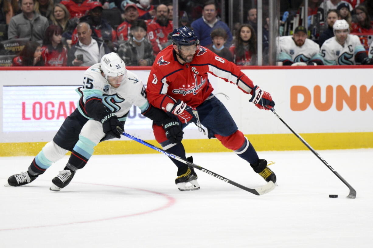 Washington Capitals left wing Alex Ovechkin (8) skates with the puck against Seattle Kraken defenseman Jeremy Lauzon (55) during the first period of an NHL hockey game, Saturday, March 5, 2022, in Washington.