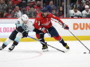 Washington Capitals left wing Alex Ovechkin (8) skates with the puck against Seattle Kraken defenseman Jeremy Lauzon (55) during the first period of an NHL hockey game, Saturday, March 5, 2022, in Washington.