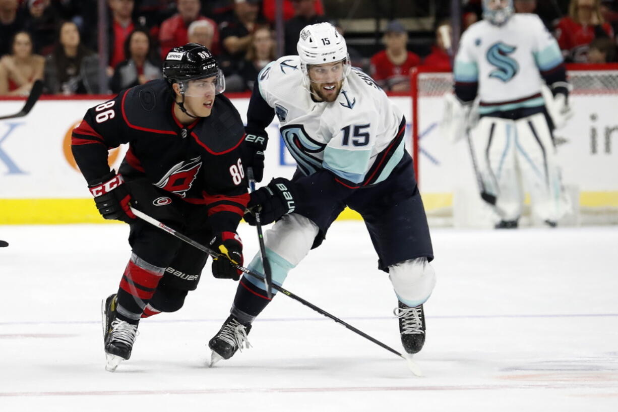 Carolina Hurricanes' Teuvo Teravainen (86) tangles with Seattle Kraken's Riley Sheahan (15) during the first period of an NHL hockey game in Raleigh, N.C., Sunday, March 6, 2022.