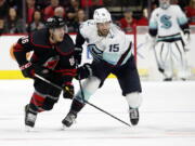 Carolina Hurricanes' Teuvo Teravainen (86) tangles with Seattle Kraken's Riley Sheahan (15) during the first period of an NHL hockey game in Raleigh, N.C., Sunday, March 6, 2022.