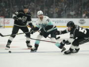 Seattle Kraken right wing Joonas Donskoi (72) passes against Los Angeles Kings right wing Arthur Kaliyev (34) and defenseman Sean Durzi (50) during the first period of an NHL hockey game Saturday, March 26, 2022, in Los Angeles.