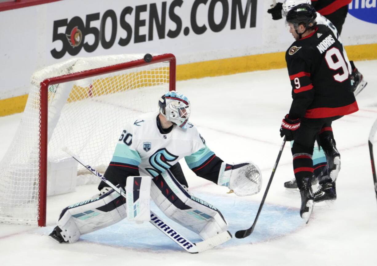 Ottawa Senators center Josh Norris (9) watches the puck go off the crossbar against Seattle Kraken goaltender Chris Driedger (60) during the third period of an NHL hockey game Thursday, March 10, 2022 in Ottawa, Ontario.(Justin Tang/The Canadian Press via AP)