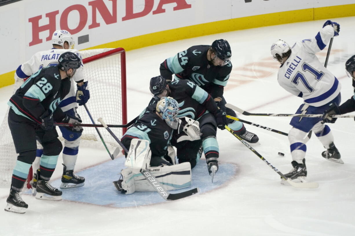 Tampa Bay Lightning center Anthony Cirelli (71) takes aim on a goal against the Seattle Kraken during the third period of an NHL hockey game Wednesday, March 16, 2022, in Seattle. (AP Photo/Ted S.