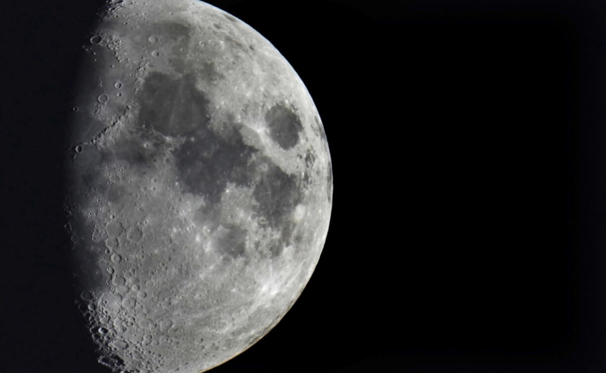 FILE - Impact craters cover the surface of the moon, seen from Berlin, Germany, Tuesday, Jan. 11, 2022. The moon is about to get walloped by 3 tons of space junk, a punch that will carve out a crater that could fit several semitractor-trailers. A leftover rocket is expected to smash into the far side of the moon at 5,800 mph (9,300 kph) on Friday, March 4, 2022, away from telescopes' prying eyes. It may take weeks, even months, to confirm the impact through satellite images.