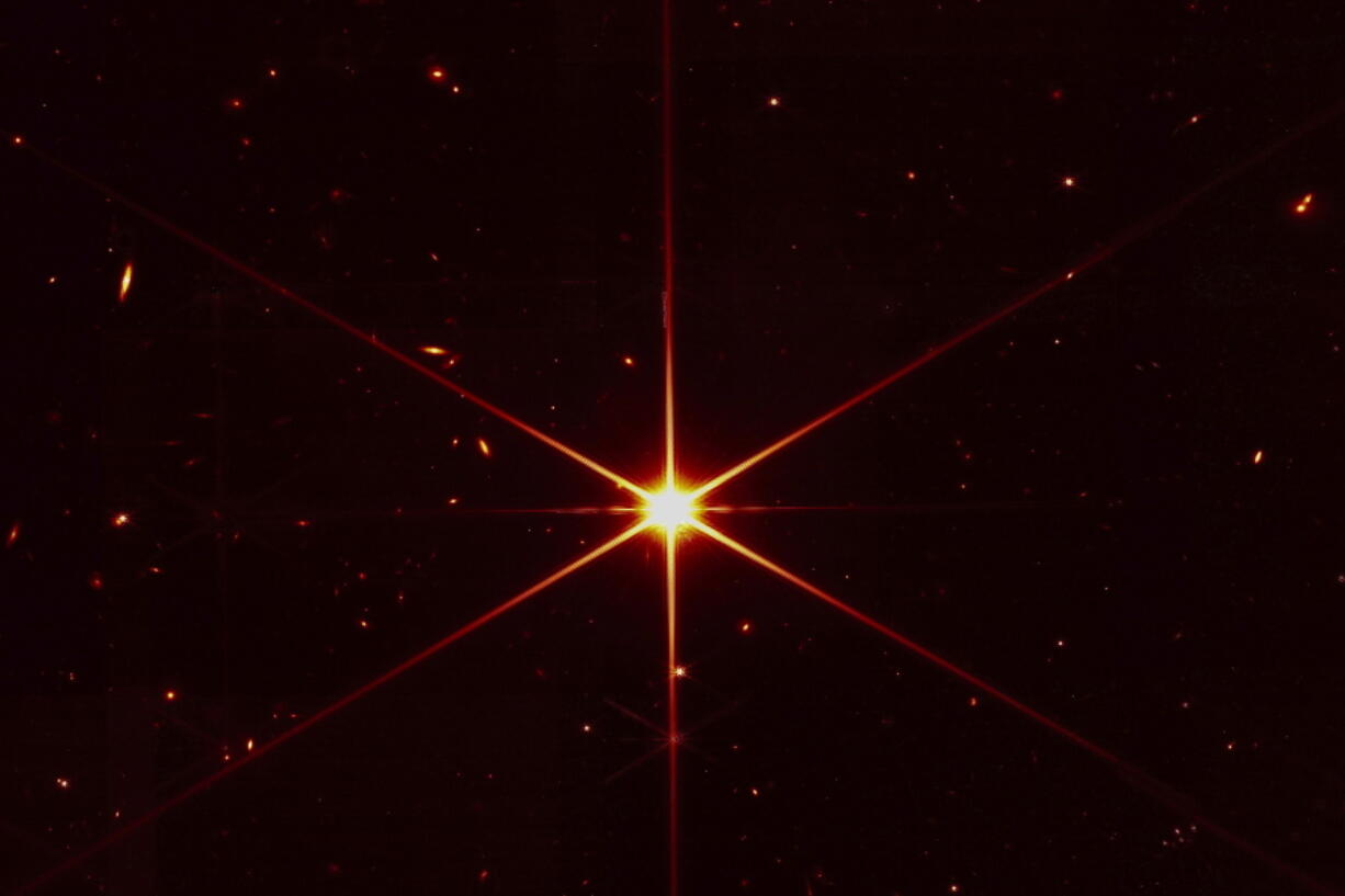 This image of a star 2,000 light-years away, with galaxies and other stars also visible, was used to align the mirrors of the James Webb Space Telescope.