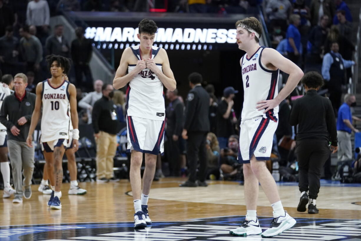 Gonzaga guard Hunter Sallis (10), center Chet Holmgren, middle, and forward Drew Timme react after Gonzaga was defeated by Arkansas in a college basketball game in the Sweet 16 round of the NCAA tournament in San Francisco, Thursday, March 24, 2022.