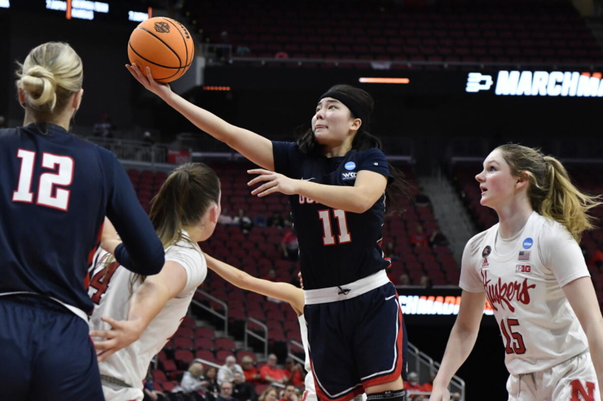 Gonzaga guard Kayleigh Truong (11) goes in for a layup past the Nebraska defense during the first half of their women's NCAA Tournament college basketball first round game in Louisville, Ky., Friday, March 18, 2022. (AP Photo/Timothy D.