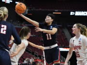 Gonzaga guard Kayleigh Truong (11) goes in for a layup past the Nebraska defense during the first half of their women's NCAA Tournament college basketball first round game in Louisville, Ky., Friday, March 18, 2022. (AP Photo/Timothy D.