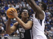 Washington State center Dishon Jackson (21) goes up for a shot with BYU forward Fousseyni Traore (45) defending during an NCAA college basketball game in the quarterfinals of the NIT, Wednesday, March 23, 2022, in Provo, Utah.