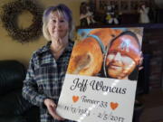 Lynn Wencus holds a poster with a likeness of her son, Jeff, on Wednesday at her home, in Wrentham, Mass. Wencus lost her son to an overdose in 2017.