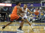 Washington guard Terrell Brown Jr., right, drives around Oregon State forward Glenn Taylor Jr., left, during the second half of an NCAA college basketball game, Saturday, March 5, 2022, in Seattle. Washington won 78-67. (AP Photo/Ted S.