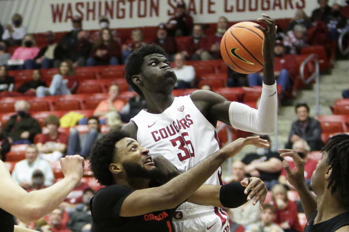 Oregon State forward Maurice Calloo, left, and Washington State forward Mouhamed Gueye go after a rebound during the second half of an NCAA college basketball game Thursday, March 3, 2022, in Pullman, Wash. Washington State won 71-67.