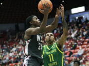 Washington State guard Noah Williams (24) drives to the basket while defended by Oregon guard Rivaldo Soares (11) during the second half of an NCAA college basketball game, Saturday, March 5, 2022, in Pullman, Wash. Washington State won 94-74.