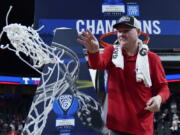 Arizona head coach Tommy Lloyd, a 1993 graduate of Kelso High School, cuts down the net after winning the Pac-12 Conference Tournament.