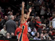 New Orleans Pelicans guard CJ McCollum reacts to the fans as he enters the game after a timeout in which a highlight video of him as a Portland Trail Blazer was played, during the first half of an NBA basketball game in Portland, Ore., Wednesday, March 30, 2022. It was the first game back in Portland for the longtime Blazer, who was traded to the Pelicans in February.