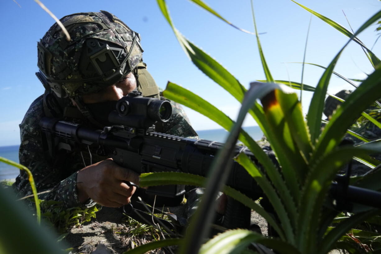 A Filipino Marine takes his position during an annual joint U.S.-Philippine war exercise titled Balikatan, Tagalog for "shoulder-to-shoulder", at Claveria, Cagayan province, northern Philippines, Thursday, March 31, 2022. U.S. and Filipino marines sprang from amphibious vehicles and transport helicopters to defend an island from potential aggressors during a military exercise and show of American firepower staged on Thursday in the northern Philippines.