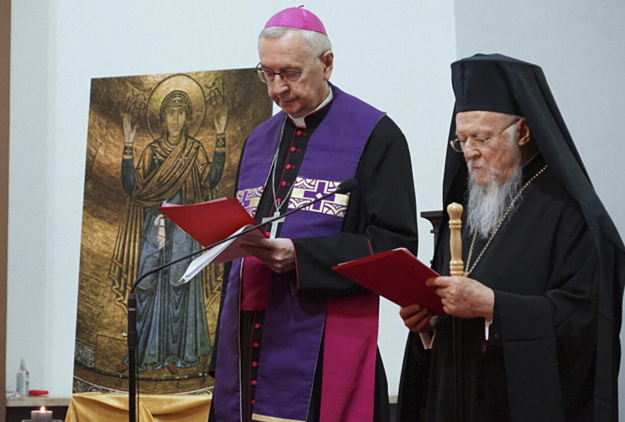 The spiritual leader of the world's Orthodox Christians, Ecumenical Patriarch Bartholomew I, right, and Archbishop Stanis?aw G?decki, the head of the Polish Bishops' Conference, stand together as they meet with Ukrainian refugees in Warsaw, Poland, on March 29, 2022.