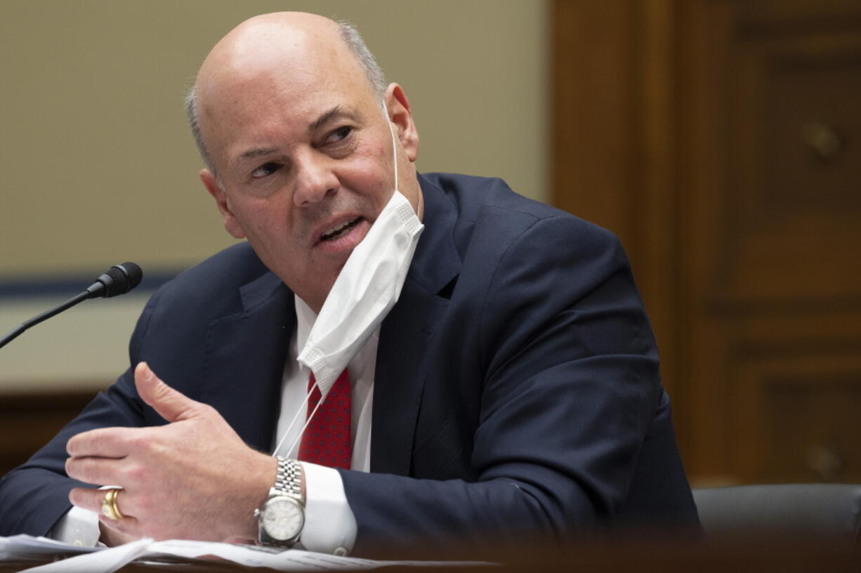 FILE - U.S. Postal Service Postmaster General Louis DeJoy speaks during a hearing on Capitol Hill, on Feb. 24, 2021, in Washington. DeJoy said Thursday, March 31, 2022, that the Justice Department has closed without criminal charges an investigation into political fundraising activity at his former business.