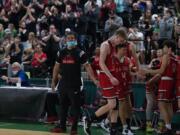 R.A. Long starters go to the bench late in the fourth quarter as head coach Jeray Key looks on during the Class 2A boys state third-place game on Saturday at Yakima Valley SunDome.