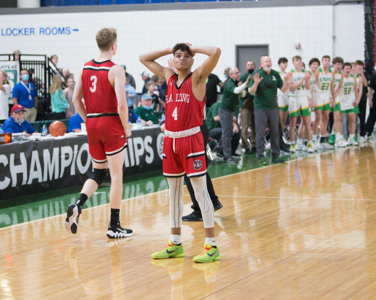 R.A. Long's Cavin Holden reacts after a turnover in the final minute of a Class 2A state semifinal boys basketball game against Lynden on Friday, March 4, 2022 in Yakima.