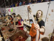 FILE -Sweetwater Jaycees clean and skinned rattlesnakes during 57th Sweetwater Jaycees World Largest Rattlesnake Round-up at the Nolan County Coliseum in Sweetwater Texas, March 14, 2015. Animal rights activists praised an annual rattlesnake roundup in south Georgia that recently changed the format of this month's event to celebrate living snakes without skinning and butchering them.