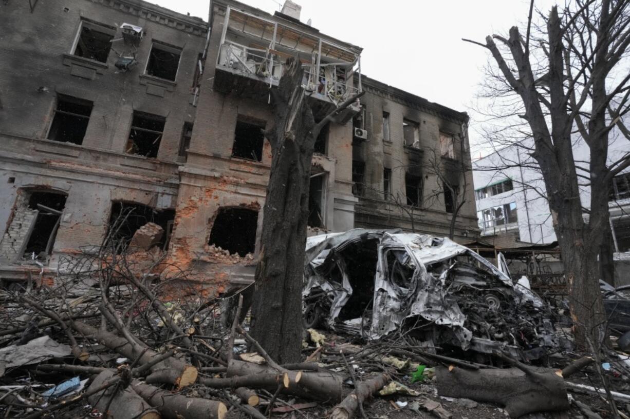 A damaged building and car after recent shelling, in the center of Kharkiv, Ukraine, Sunday, March 27, 2022.