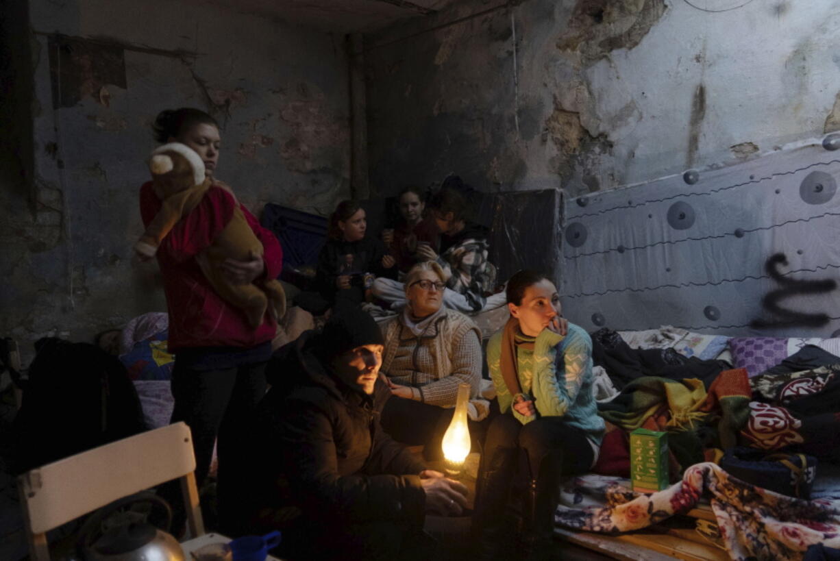 People settle in a bomb shelter in Mariupol, Ukraine, Sunday, March 6, 2022.