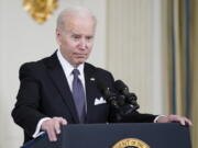 President Joe Biden listens to a question from a reporter about Russian President Vladimir Putin after speaking about his proposed budget for fiscal year 2023 in the State Dining Room of the White House, Monday, March 28, 2022, in Washington.