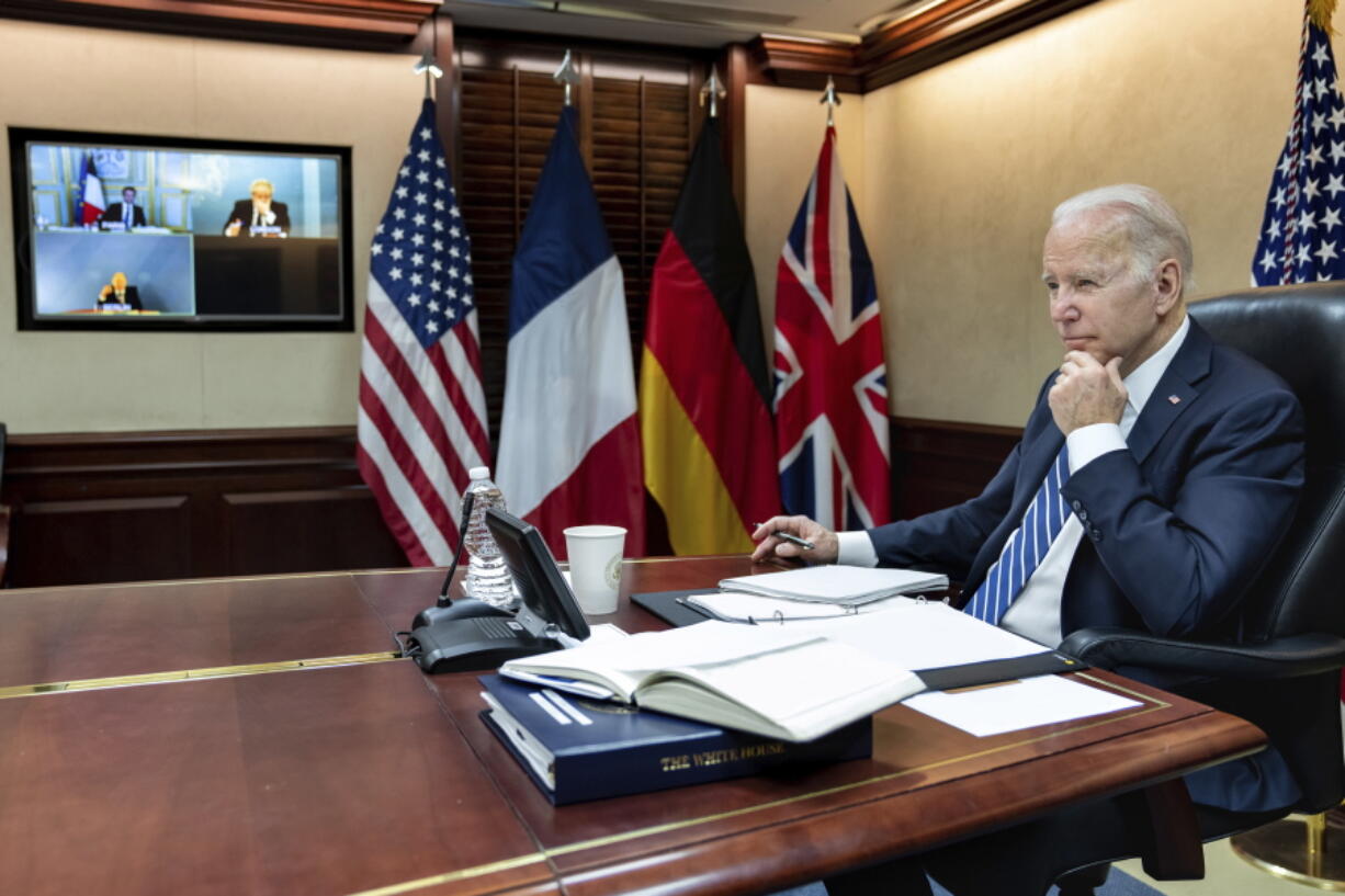 In this image provided by the White House, President Joe Biden listens during a secure video call with French President Emmanuel Macron, German Chancellor Olaf Scholz and British Prime Minister Boris Johnson in the Situation Room at the White House Monday, March 7, 2022, in Washington.