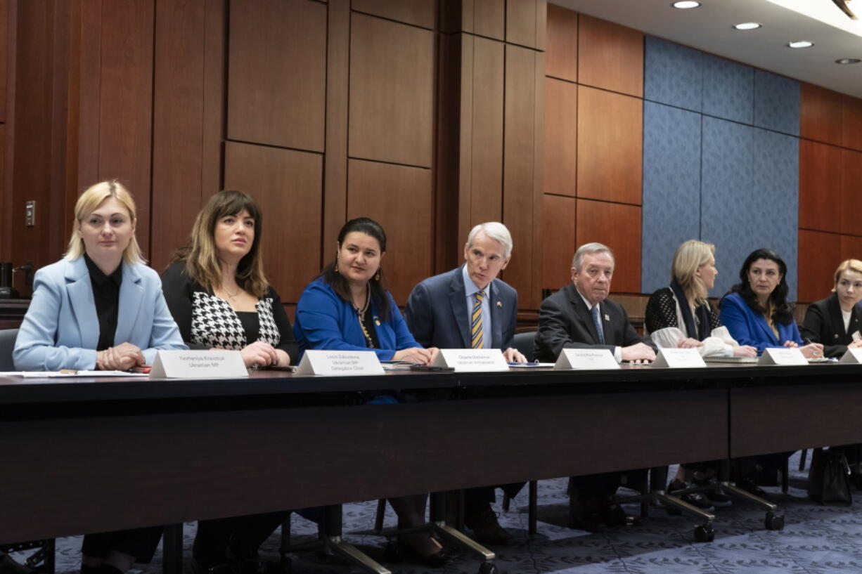 Sen. Rob Portman, R-Ohio, center, and Sen. Dick Durbin, D-Ill., right, hold a meeting with members of the Ukrainian Parliament, at the Capitol in Washington, Wednesday, March 30, 2022. From left are: Ukrainian Parliament members Yevheniya Kravchuk and Lesia Zaburanna, Ukrainian Amb. Oksana Markarova, Sen. Rob Portman, R-Ohio, Sen. Dick Durbin, D-Ill., Ukrainian Parliament members Maria Ionova, Ivanna Klympush-Tsintsadze, and Anastasia Radina. (AP Photo/J.