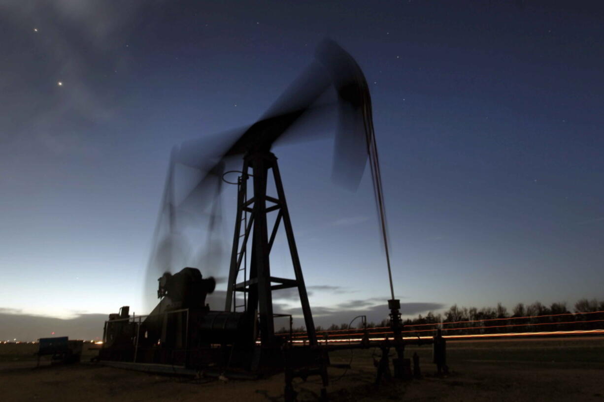 FILE - A pumping unit sucks oil from the ground near Greensburg, Kan. on March 6, 2012. The International Energy Agency says all 31 member countries have agreed to release 60 million barrels of oil from their strategic reserves "to send a strong message to oil markets" that there will be "no shortfall in supplies" as a result of Russia's invasion of Ukraine. The IEA board made the decision Tuesday, march 1, 2022 at an extraordinary meeting of energy ministers chaired by U.S. Energy Secretary Jennifer Granholm.