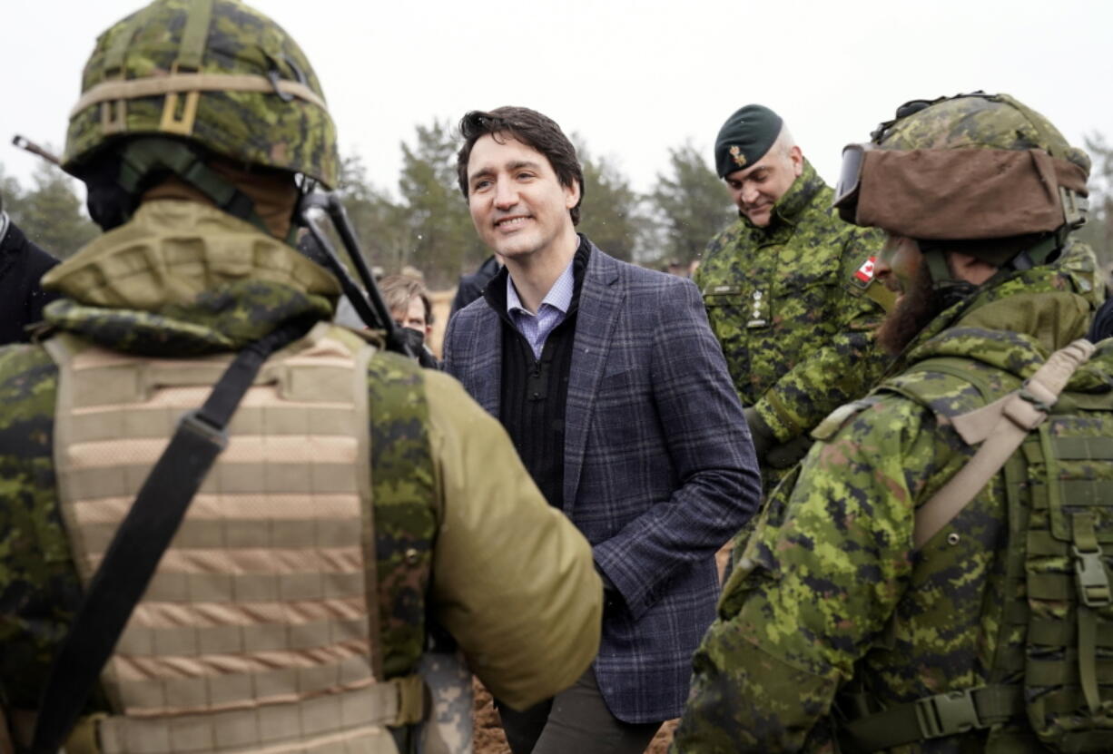 Canadian Prime Minister Justin Trudeau smiles while speaking to Canadian troops during his visit to Adazi Military base in Kadaga, Latvia, on March. 8, 2022.