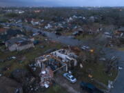 Debris litters the ground surrounding homes, damaged by a tornado, on Oxford Drive and Stratford Drive in Round Rock, Texas Monday, March 21, 2022.