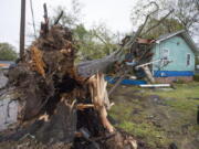 A house on Summer Street, just north of Winter Street, in Jackson, Miss., was heavily damaged by a downed tree during severe weather that moved through the city Wednesday, March 30, 2022.(Barbara Gauntt/The Clarion-Ledger via AP)