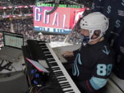 Seattle Kraken organist Rod Masters performs after a goal was scored during an NHL hockey game against the Florida Panthers at Climate Pledge Arena, on Jan. 23, 2022, in Seattle. Masters played the role of the organist in "Slap Shot," the iconic 1977 hockey movie starring Paul Newman, and now he's now part of the fraternity of organists playing in arenas around the NHL. (AP Photo/Ted S.