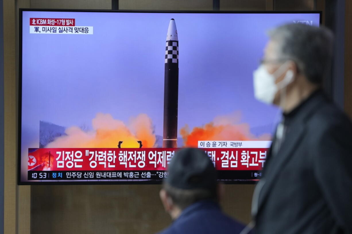 People watch a TV screen showing a news program reporting about North Korea's ICBM at a train station in Seoul, South Korea, Friday, March 25, 2022. North Korea said Friday it test-fired its biggest-yet intercontinental ballistic missile under the orders of leader Kim Jong Un, who vowed to expand the North's "nuclear war deterrent" while preparing for a "long-standing confrontation" with the United States.